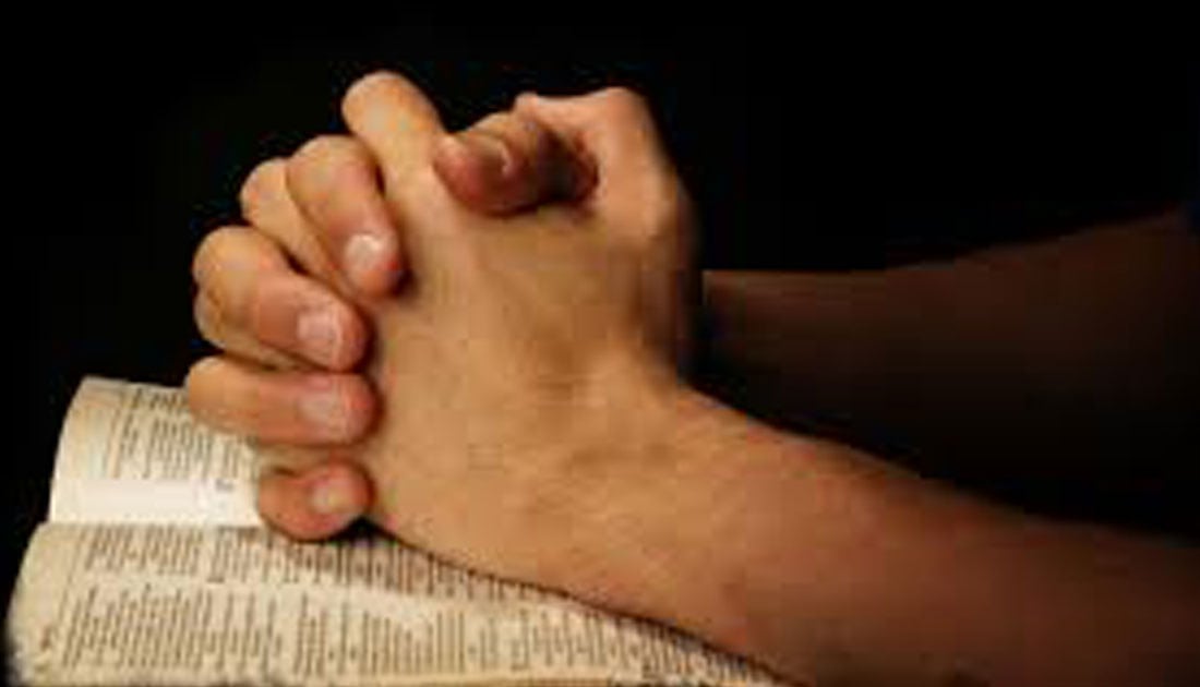 praying-hands-on-bible - Christian Heritage Academy